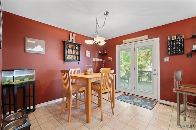 dining room with baseboards, light tile patterned flooring, and visible vents