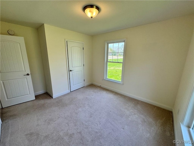 unfurnished bedroom with baseboards and carpet flooring