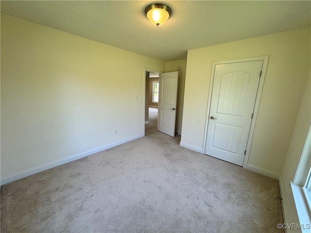 unfurnished bedroom with carpet floors and baseboards