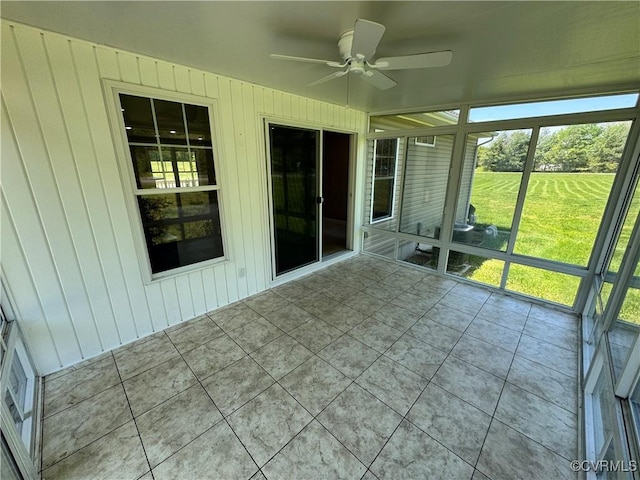 unfurnished sunroom with a healthy amount of sunlight and a ceiling fan
