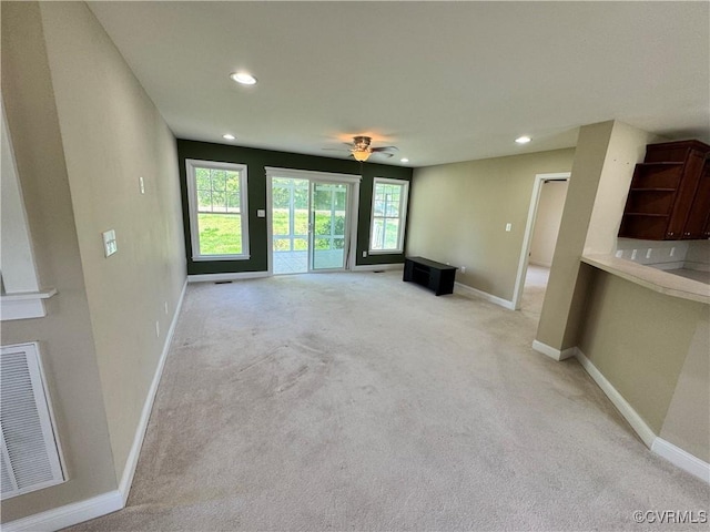 unfurnished living room featuring visible vents, recessed lighting, baseboards, and light colored carpet