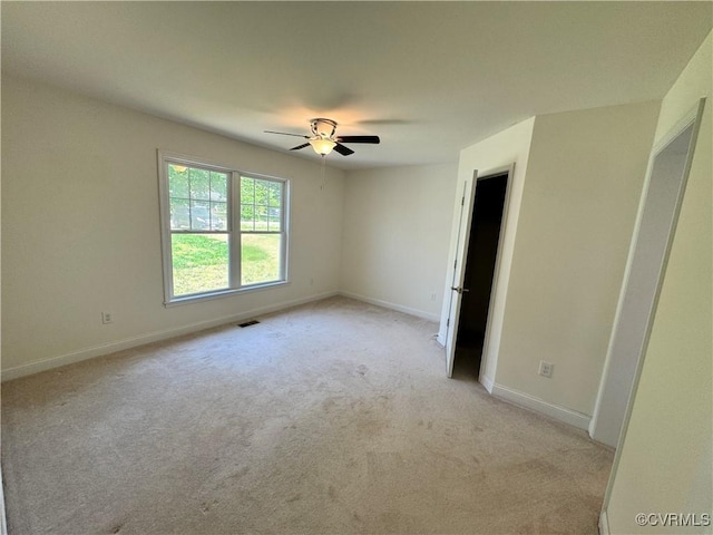 unfurnished bedroom with baseboards, light carpet, a ceiling fan, and visible vents