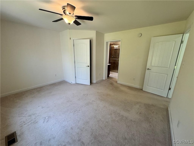 unfurnished bedroom with light colored carpet, a ceiling fan, baseboards, ensuite bathroom, and visible vents