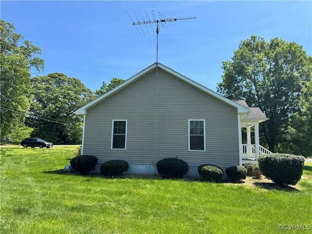view of side of home with a yard