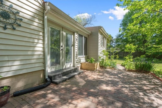view of home's exterior with fence and a patio