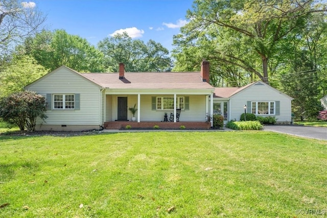 single story home featuring a porch, aphalt driveway, a chimney, and a front lawn