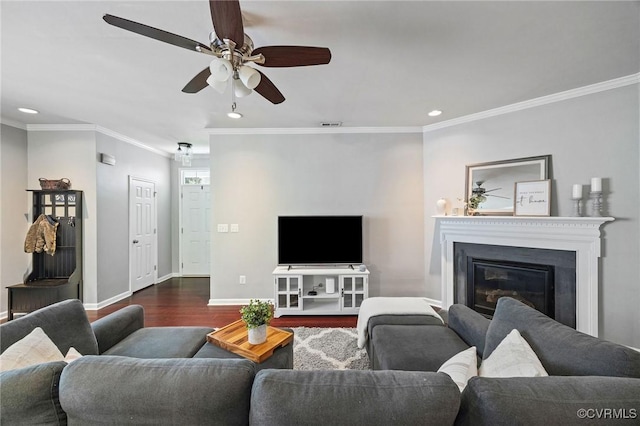 living room with crown molding, baseboards, recessed lighting, a ceiling fan, and dark wood finished floors