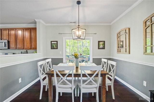 dining space with ornamental molding, dark wood-style flooring, and a wealth of natural light