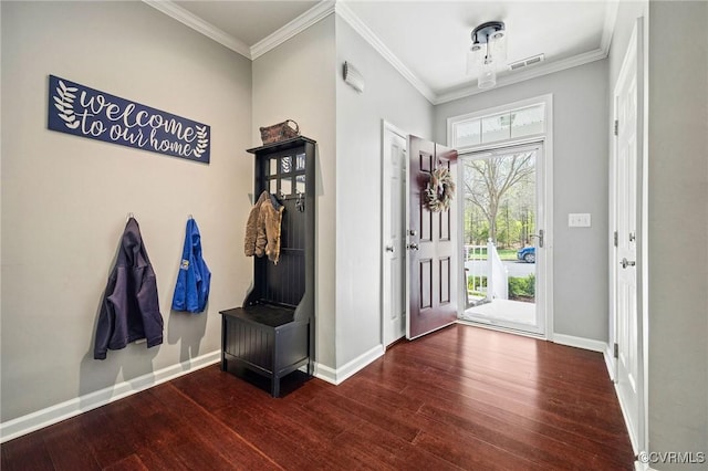 foyer entrance with baseboards, ornamental molding, and wood-type flooring