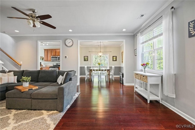 living room with a ceiling fan, visible vents, hardwood / wood-style flooring, stairway, and ornamental molding