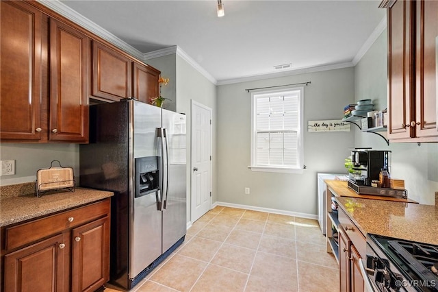 kitchen with visible vents, ornamental molding, baseboards, light tile patterned floors, and stainless steel appliances