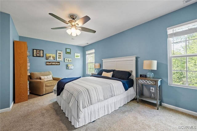 carpeted bedroom with baseboards and a ceiling fan