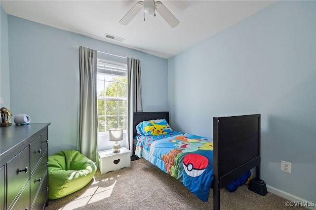carpeted bedroom featuring visible vents and a ceiling fan