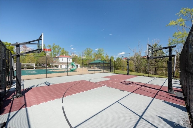 view of basketball court featuring community basketball court and fence