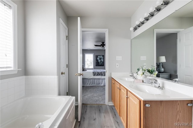 8134 Falling Leaf Ct, Mechanicsville, VA 23111 - ensuite bathroom featuring wood finished floors, double vanity, a bath, and a ceiling fan