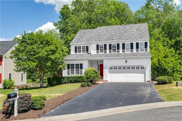 8134 Falling Leaf Ct, Mechanicsville, VA 23111 - traditional-style house with an attached garage, asphalt driveway, a front yard, and roof with shingles