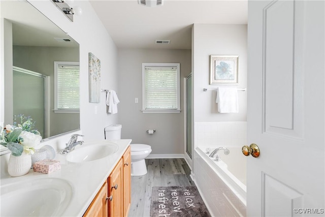 8134 Falling Leaf Ct, Mechanicsville, VA 23111 - bathroom featuring double vanity, a stall shower, a garden tub, and wood finished floors
