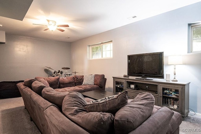 living area featuring plenty of natural light, ceiling fan, and carpet flooring