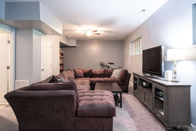 living room with ceiling fan, visible vents, and light carpet