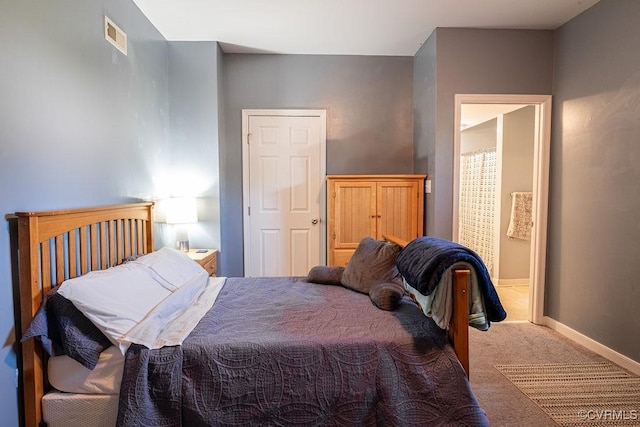 carpeted bedroom featuring baseboards and visible vents