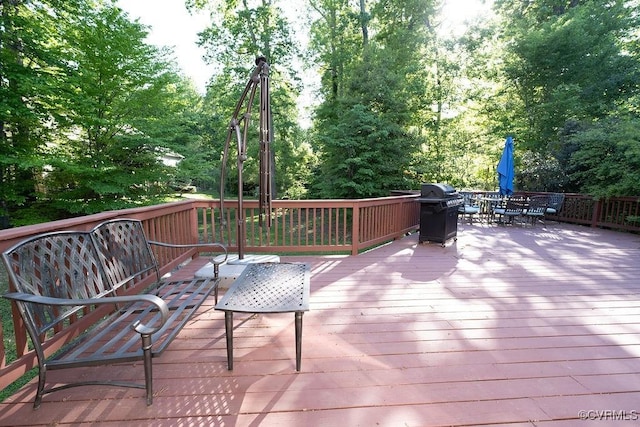 wooden terrace with grilling area and outdoor dining space