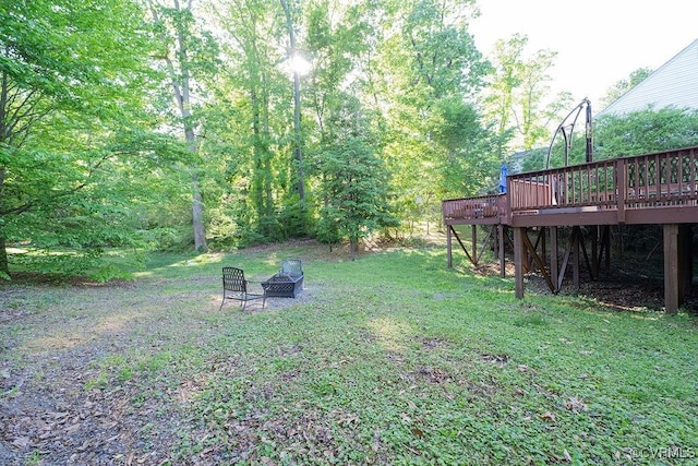 view of yard featuring a fire pit and a deck