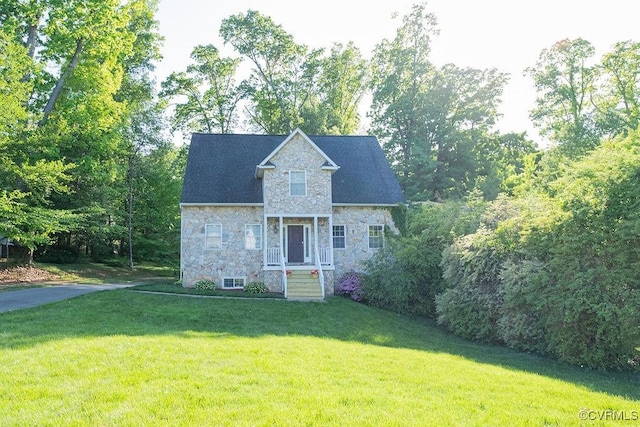 view of front of property with a front lawn and stone siding
