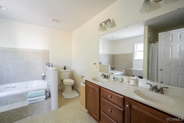 bathroom with a sink, a garden tub, toilet, and visible vents