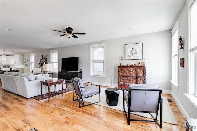 1207 N 21st St, Richmond, VA 23223 - living room with ceiling fan, baseboards, and light wood-type flooring