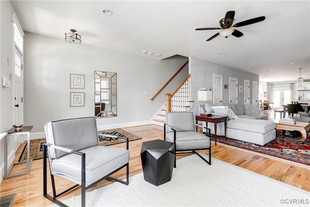 1207 N 21st St, Richmond, VA 23223 - living room with stairway, a ceiling fan, light wood finished floors, and visible vents