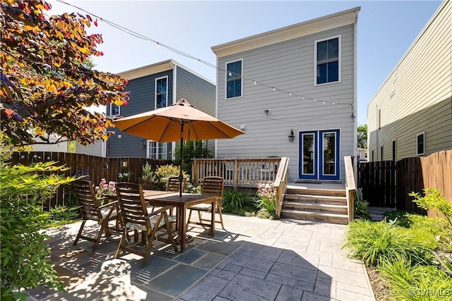 1207 N 21st St, Richmond, VA 23223 - rear view of property featuring a patio, fence, a deck, and outdoor dining space