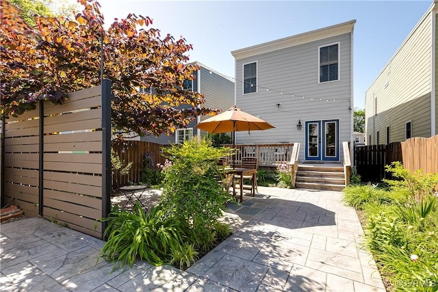 1207 N 21st St, Richmond, VA 23223 - back of property featuring fence, a patio, and a deck