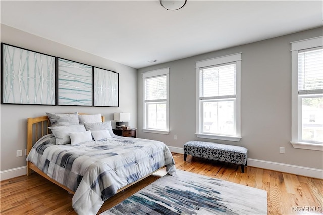 1207 N 21st St, Richmond, VA 23223 - bedroom featuring baseboards, multiple windows, and wood finished floors