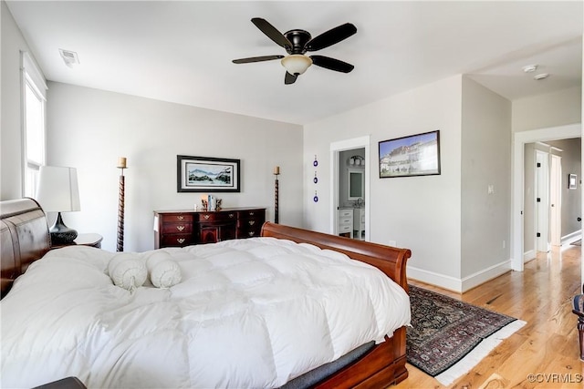 1207 N 21st St, Richmond, VA 23223 - bedroom with ensuite bath, a ceiling fan, baseboards, light wood-type flooring, and visible vents
