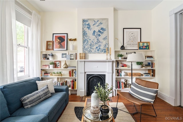 sitting room featuring a fireplace and wood finished floors