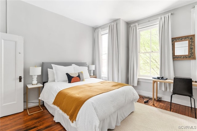 bedroom with baseboards and wood finished floors