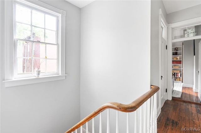 hallway with baseboards and hardwood / wood-style flooring