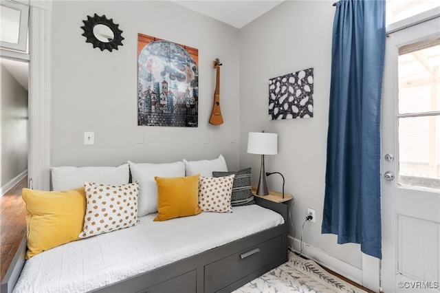 bedroom featuring baseboards and light wood-style flooring