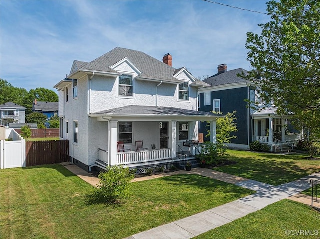 view of front of property with fence, covered porch, stucco siding, and a front lawn