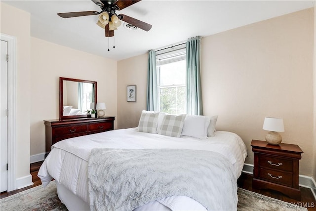 bedroom featuring baseboards, a ceiling fan, and wood finished floors