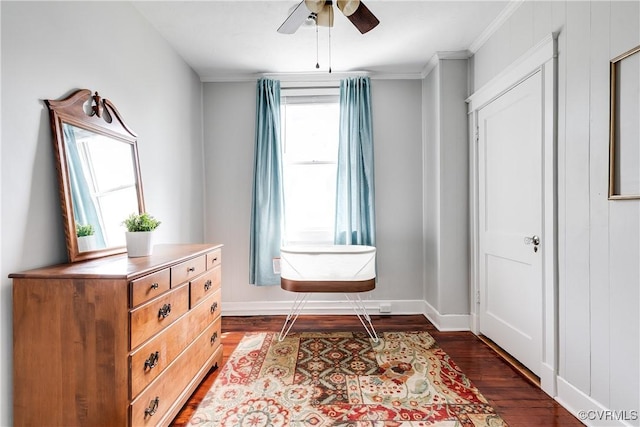 interior space featuring crown molding, ceiling fan, dark wood finished floors, and baseboards