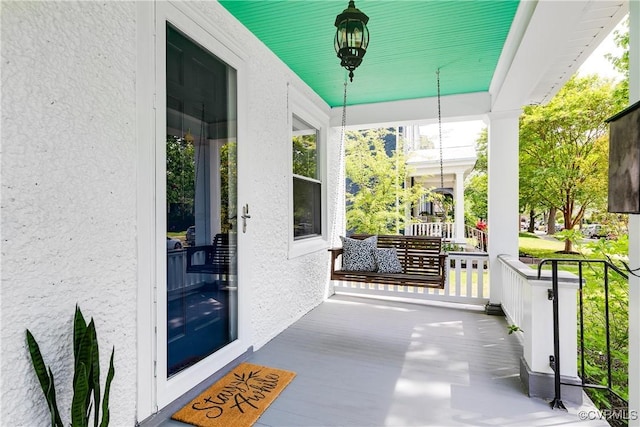 exterior space with stucco siding and covered porch