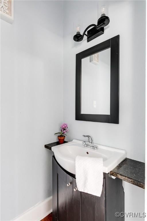 bathroom featuring baseboards and vanity