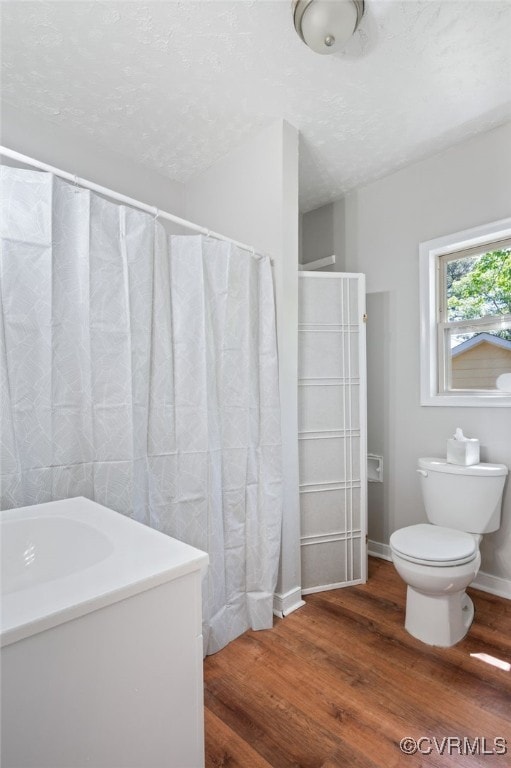 1207 Edgewood Blvd, Hopewell, VA 23860 - bathroom with a textured ceiling, toilet, and wood finished floors
