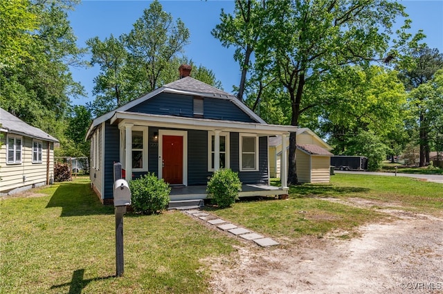 1207 Edgewood Blvd, Hopewell, VA 23860 - bungalow featuring a porch, a front lawn, and a chimney