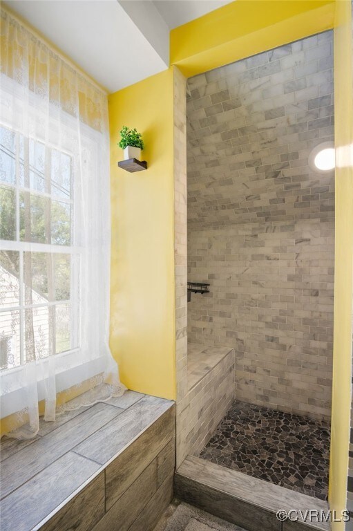 full bathroom with tiled shower