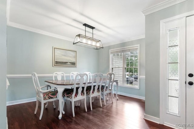dining space with baseboards, ornamental molding, and dark wood-style floors