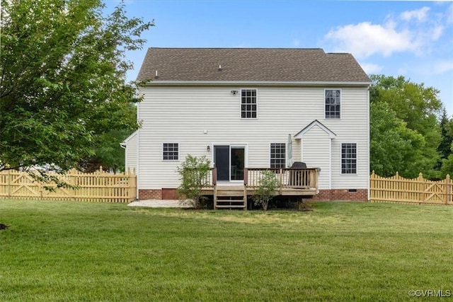 rear view of house with a lawn, crawl space, a wooden deck, and a fenced backyard