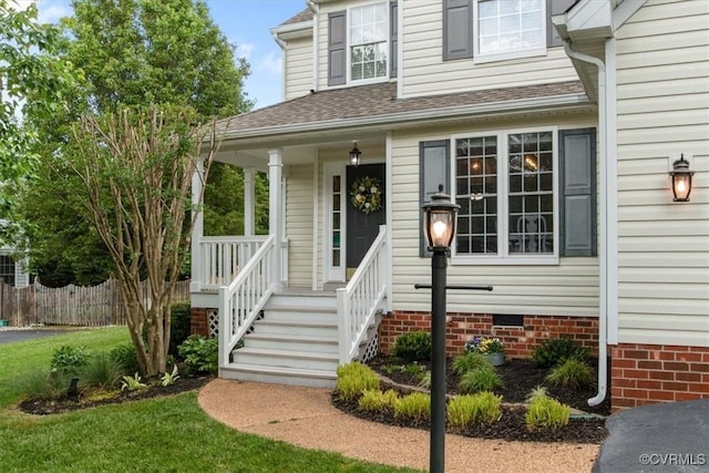 property entrance with a porch, roof with shingles, fence, and crawl space