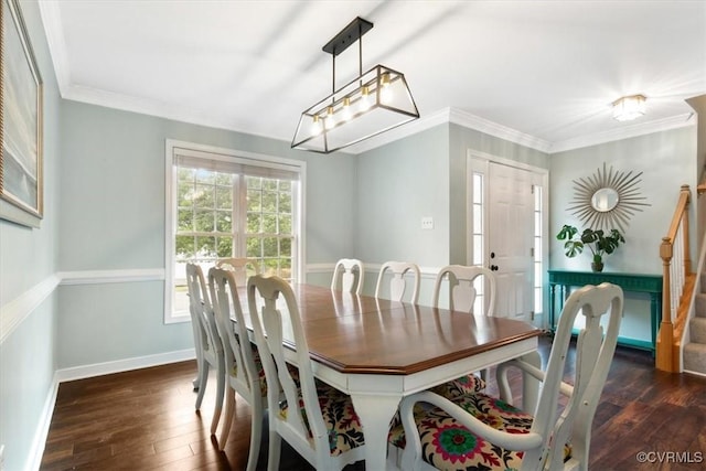 dining area featuring crown molding, dark wood finished floors, baseboards, and stairs
